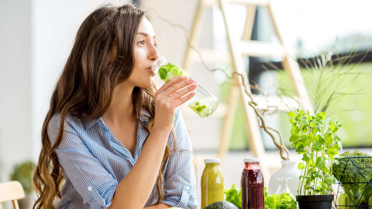 Young woman drinking a detox juice