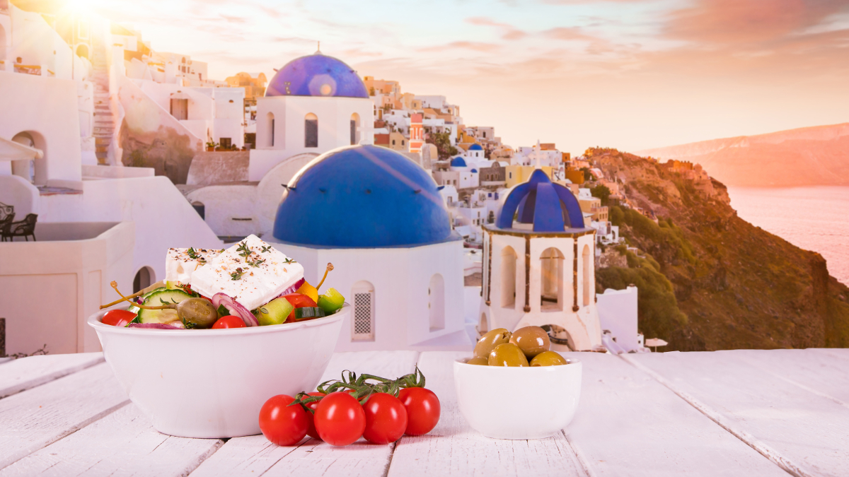 Mediterranean diet with tomatoes and olives, with the Greek landscape in the background